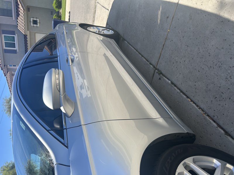 Detailed silver Ford Fusion, side profile exterior view