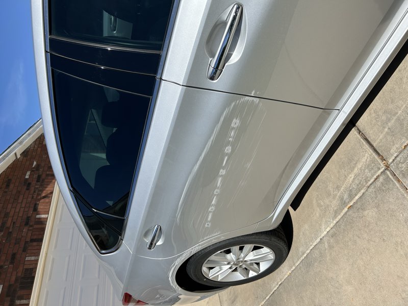 Detailed silver sedan, rear passenger door exterior view