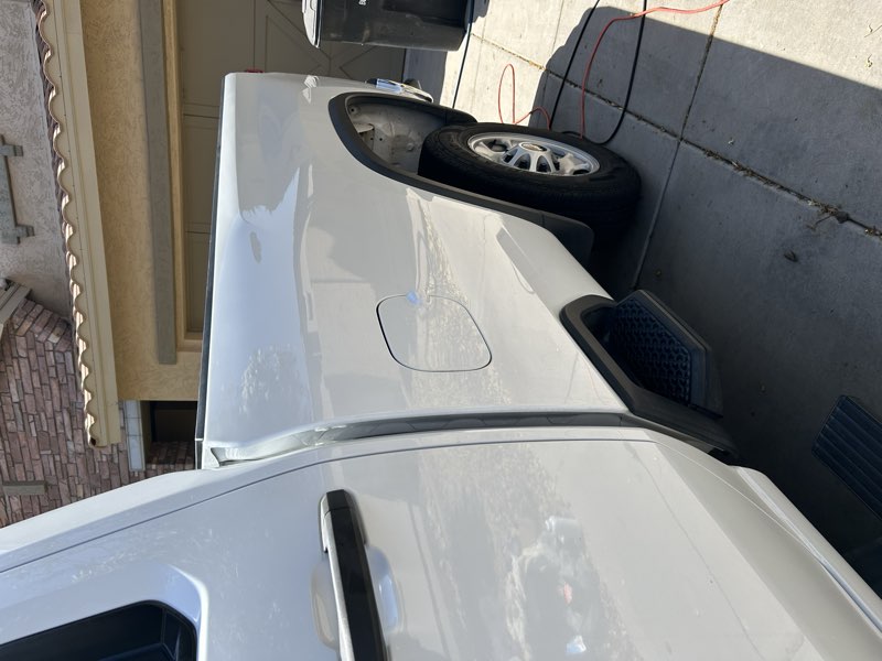Detailed white pickup truck, fender and fuel door exterior view